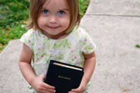 Young girl holding bible